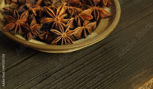 Anise stars lie on a ceramic plate