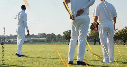 Coach walking to yellow cones, pointing and showing bowling run-up on cricket field guiding team