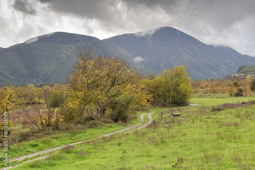 Rural path in the mountains in autumn (Peloponnese, Greece) on a cloudy, foggy day