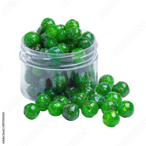 A clear jar filled with green beads on a black background