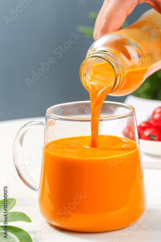 Fresh Sea Buckthorn Juice Pouring Into Glass Mug