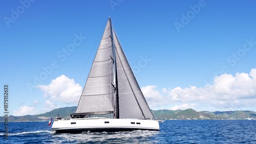 catamaran sails into view in the British Virgin Islands