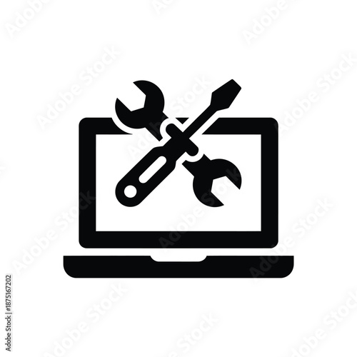 Laptop with wrench and screwdriver on screen