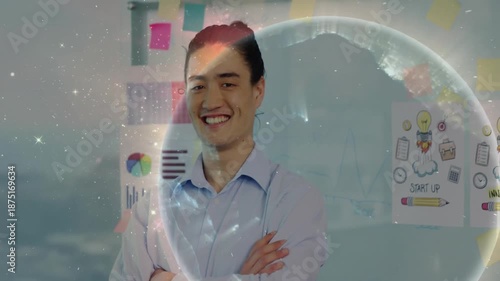 Japanese business executive standing by whiteboard, starting rotating globe showing global network