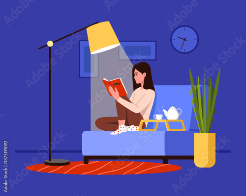 Vector illustration of a girl reading a book in the evening. Cartoon of a girl reading a book under a floor lamp in an armchair, with a tray, a teapot and a cup of tea, isolated on a blue background.