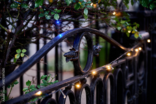 Metal fence panel with string lights changing position