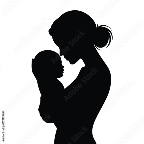 silhouette of a woman holding and kissing a baby