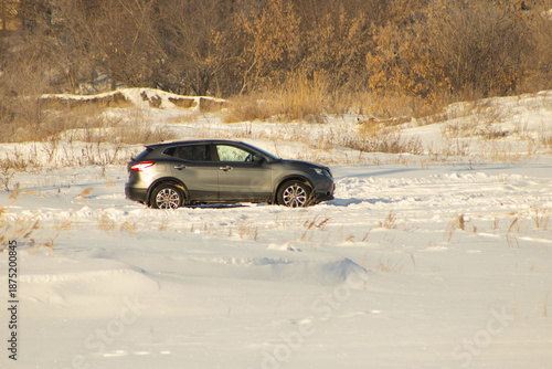 Modern SUV Driving Through Snowy Winter Landscape
