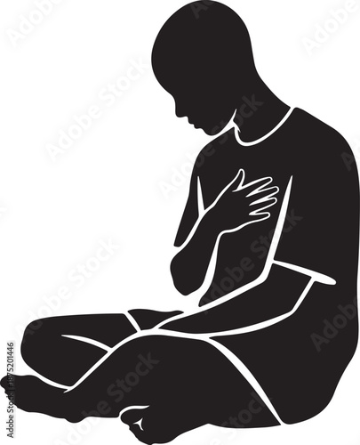 Silhouette of a man sitting in meditation or prayer