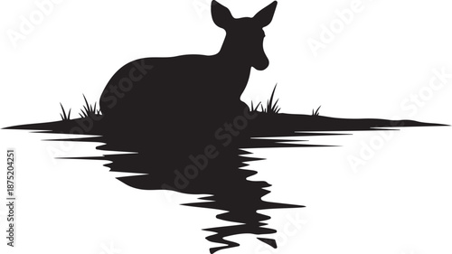 Serene Deer Silhouette Resting by Calm Water's Edge Peacefully