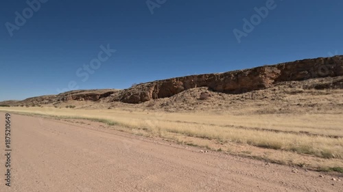Driving on dusty roads near rocks in Namibia, Africa.