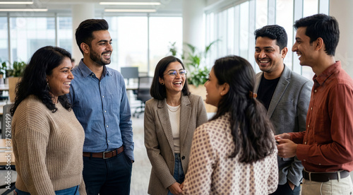 Enthusiastic indian corporate team enjoying convivial break in modern co-working hub