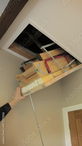 4K: Opening a Loft or Attic Hatch with a metal rod towards the ceiling. Vertical. Stock Video Clip Footage.