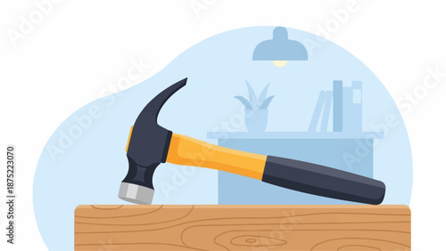 A claw hammer rests on a wooden plank, with a desk and lamp in the background