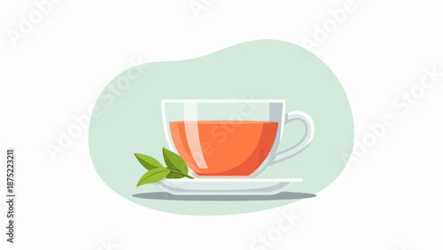 A clear glass cup filled with orange liquid and two green leaves rests on a saucer