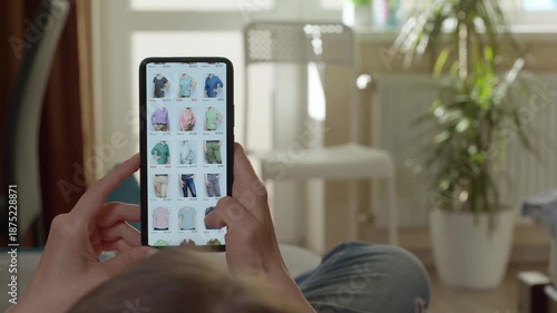 Person holding smartphone with app icons in a cozy living room with natural light