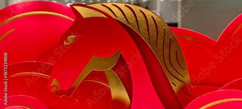 Stylized red and gold horse head art banner with festive detailing, symbolic of Chinese New Year zodiac. 