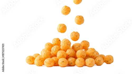Delicious cheese puffs falling on top of a pile of cheese balls isolated on white background