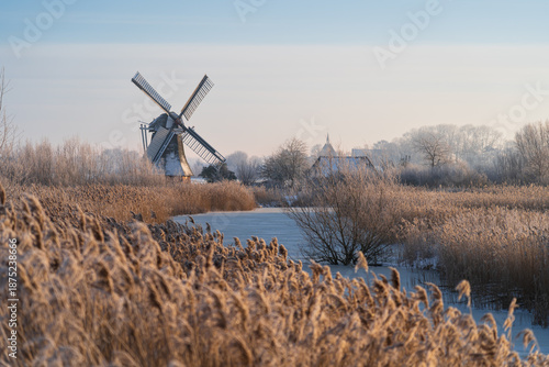 A cold, winter morning at a traditional windmill in the Dutch countryside.