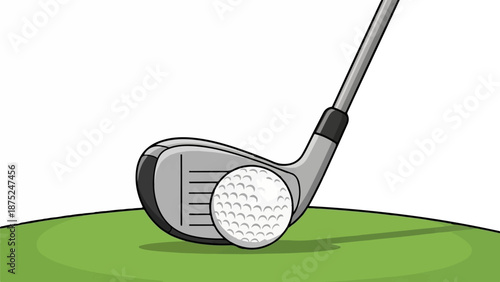 A golf club poised to strike a dimpled ball on a green turf