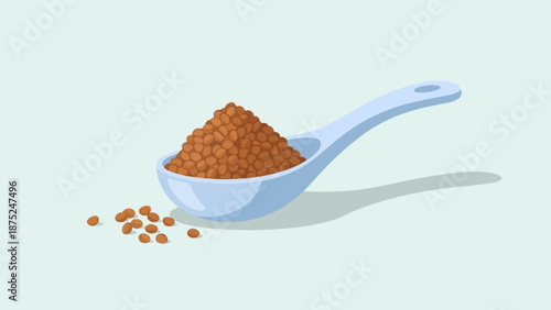 A light blue spoon holds a pile of small brown beans with some scattered nearby