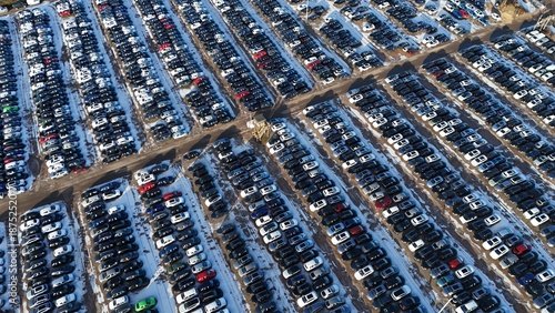 Aerial view of cars tightly packed in rows, creating a mesmerizing grid of color and texture with snow, Corby, England, United Kingdom.