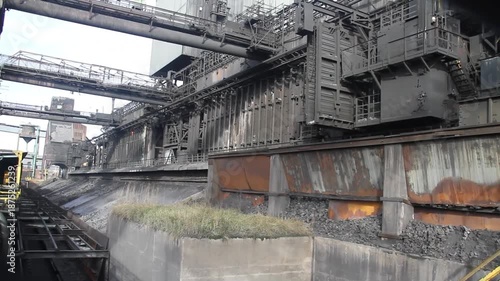 Coke oven plant in operation producing hard but reactive metallurgical coke for blast furnace use.