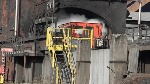 Coke oven plant in operation producing hard but reactive metallurgical coke for blast furnace use.