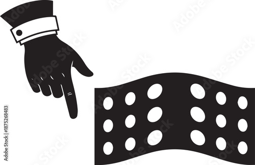 A hand in a formal cuffed sleeve points to a black fabric with white polka dots