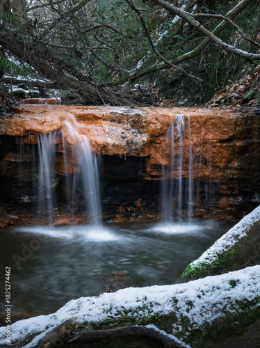 Marline valley waterfall during winter snow on the high weald near Hastings east Sussex south east England UK