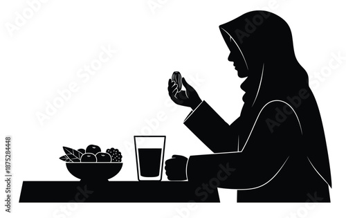 Woman eating dates to break fasting during ramadan iftar