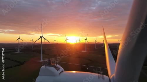 Wind turbines at sunset in a field