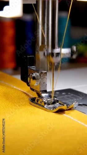 Close-up of sewing machine stitching fabric in studio workspace during afternoon