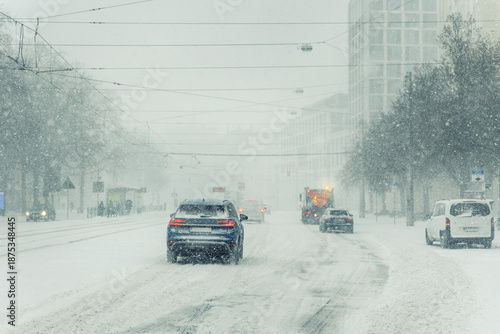 фотографія Heavy snowfall cover urban street Magdeburg car service truck move low visibility icy condition