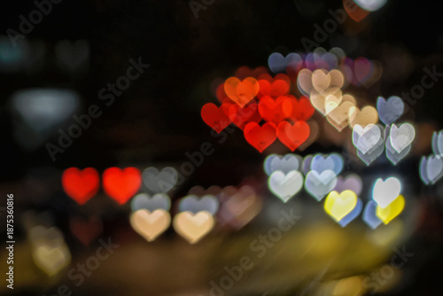 Abstract heart shaped bokeh lights creating a romantic and dreamy atmosphere. Soft colorful light background ideal for love, Valentine’s Day, wedding and emotional design concepts