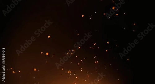 Dark cinematic video background with small glowing fire sparks gently floating in the air. Warm orange and amber particles create a soft, elegant and atmospheric motion on a dark backdrop.
