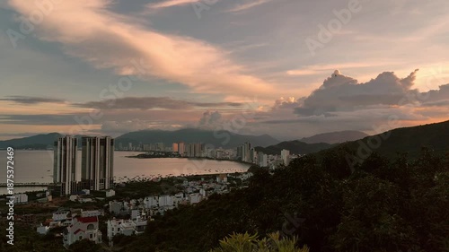 Panoramic cityscape view of Nha Trang from Chua Da Bao Pagoda in Vietnam. Scenic mountain viewpoint overlooking the coastal city, blue sea, and skyline under bright tropical sky. Peaceful combination