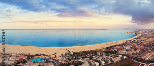 Aerial view of Chaves beach with luxury resort,blue ocean and dramatic sky at sunrise, Boa Vista, Cape Verde