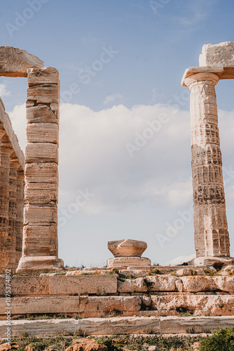 Ruins of the Temple of Poseidon, Ancient Greek Architecture Detail, Close-up view of broken stone columns from the ancient Temple of Poseidon at Cape Sounion, Greece. Weathered ruins showcasing the pa