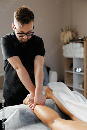 Physiotherapist performing leg massage for muscle recovery