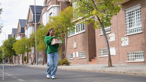 Wallpaper Mural Young smiling woman carrying a basket of fresh vegetables home Torontodigital.ca