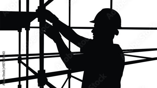 Construction worker in silhouette working on scaffolding at building site