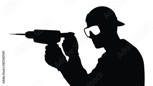Construction worker in silhouette using power drill with safety gear