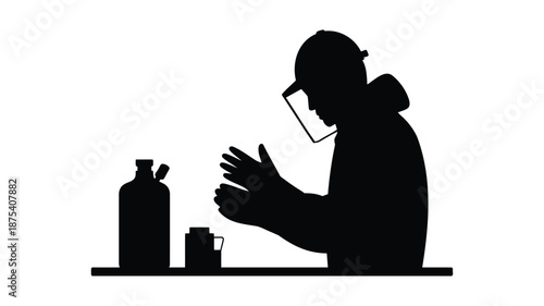 Man in protective gear handling equipment with bottle