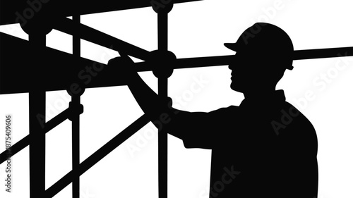 Construction worker in silhouette working on scaffolding structure
