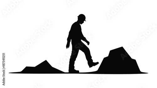 Man in hard hat climbing over rocks