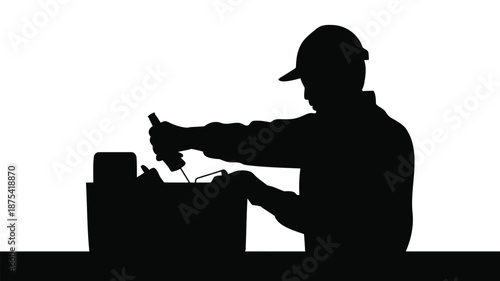 Silhouette of worker using power tool on construction site