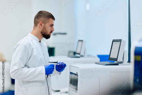 Laboratory technician examines data at high-tech lab during research session