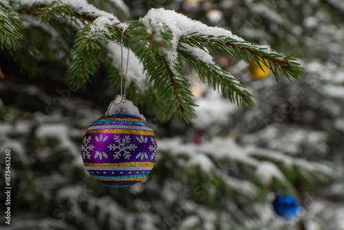 Christmas tree decoration on a snowy spruce branch