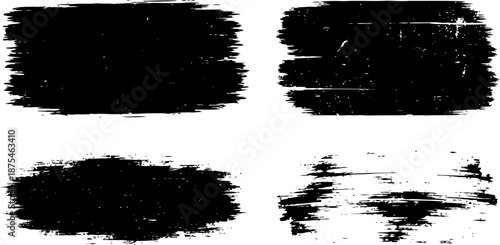 Set of four black brush stroke textures on white background for grunge and vintage design